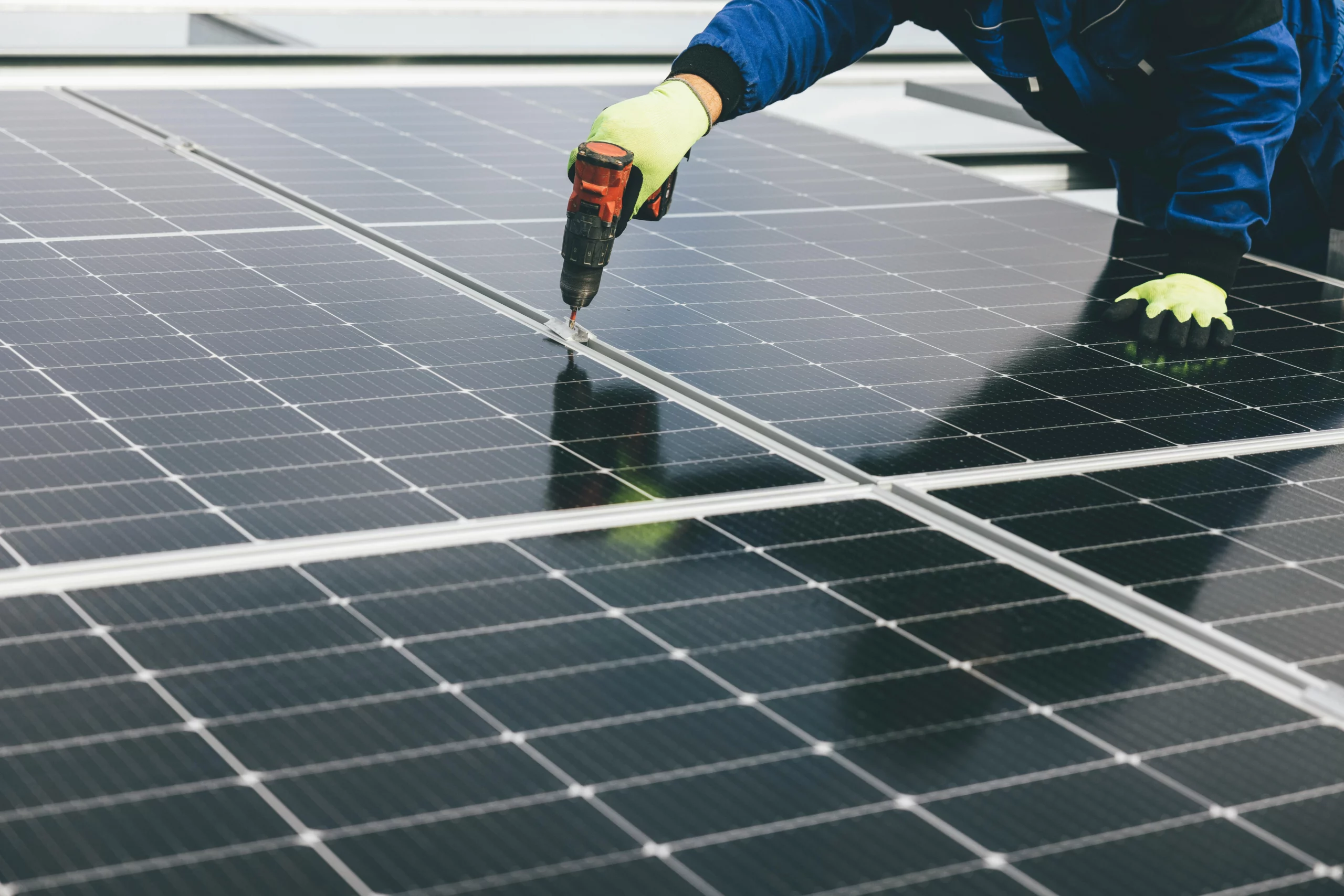 Techniker überprüft Solarmodule auf einem Dach – Photovoltaik Dachflächen